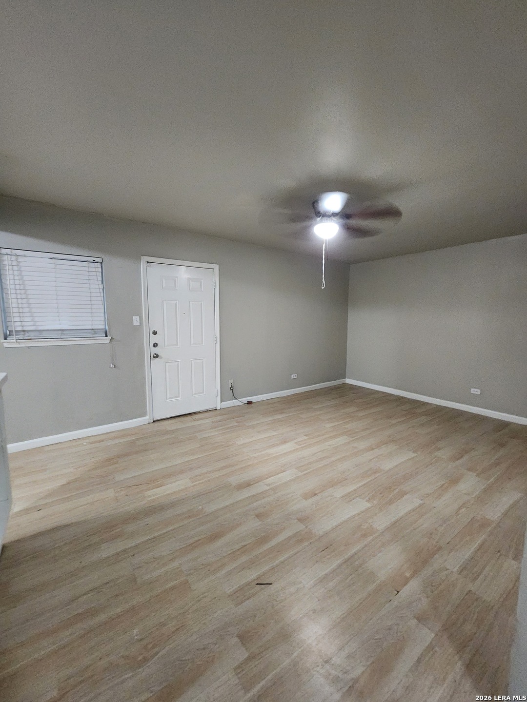 615 Vance Jackson Road, Unit 204 San Antonio, TX 78201 - Photo 8 of 14 a view of an empty room with a chandelier fan