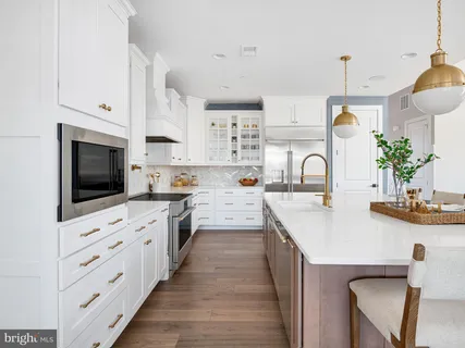 a kitchen with cabinets a sink and appliances