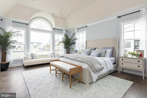 a spacious bedroom with a bed and a large window