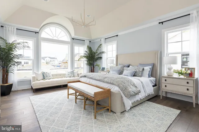 a spacious bedroom with a bed and a large window