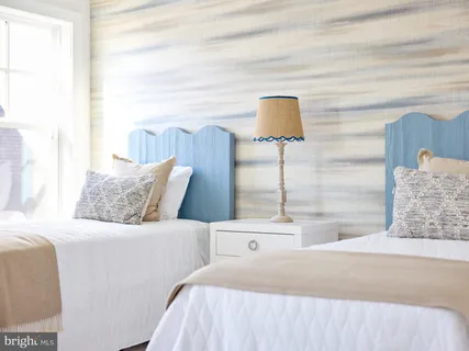 a bedroom with a bed and a lamp