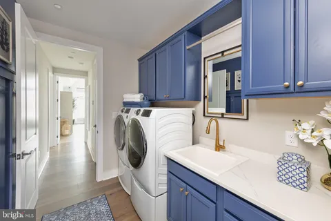 a utility room with sink dryer and washer