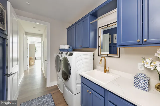 a utility room with sink dryer and washer
