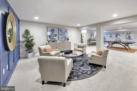 a living room with furniture a flat screen tv and a floor to ceiling window