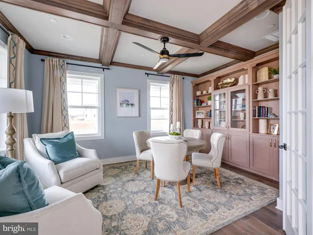 a living room with furniture a flat screen tv and a table