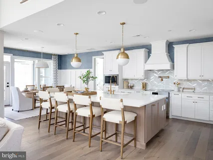 a large kitchen with lots of counter space and furniture