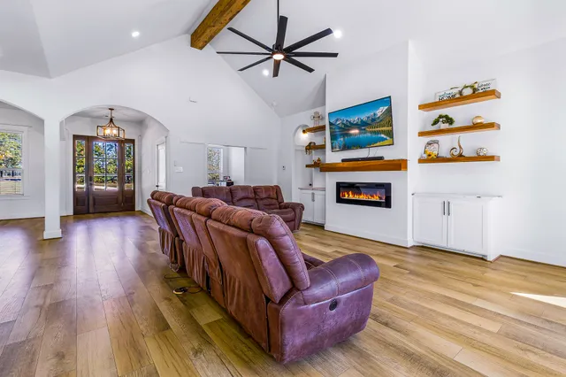 a kitchen with kitchen island a stove a sink a refrigerator and wooden floor