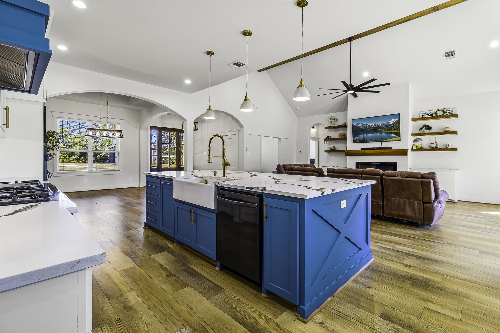 440 Farm To Market 223 Shepherd, TX 77371 - Photo 14 of 49 a kitchen with kitchen island a stove a sink a refrigerator and wooden floor