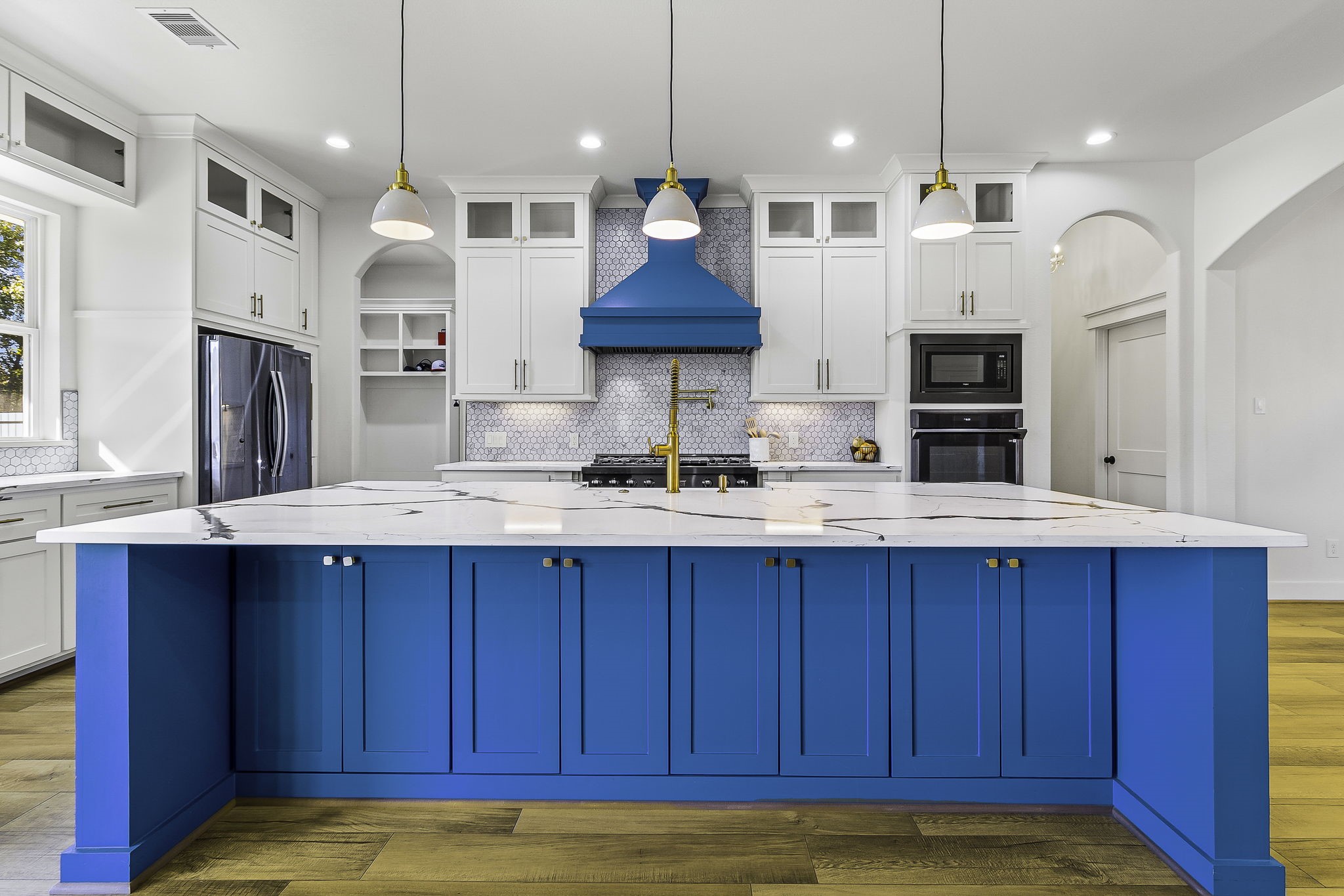 440 Farm To Market 223 Shepherd, TX 77371 - Photo 21 of 49 a kitchen with stainless steel appliances wooden cabinets a sink a center island and chairs
