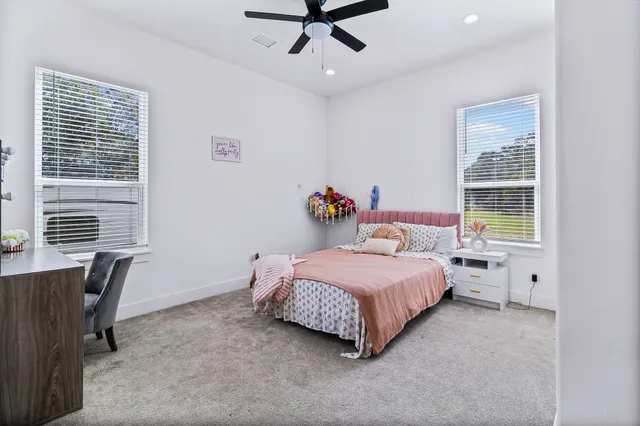 a bedroom with a bed couch and window