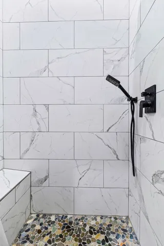 a white toilet sitting next to a bathroom sink