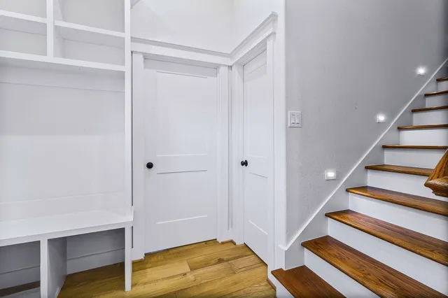 a view of entryway and hall with wooden floor