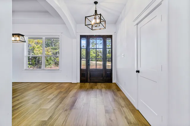 a large living room with stainless steel appliances granite countertop furniture a fireplace and a flat screen tv