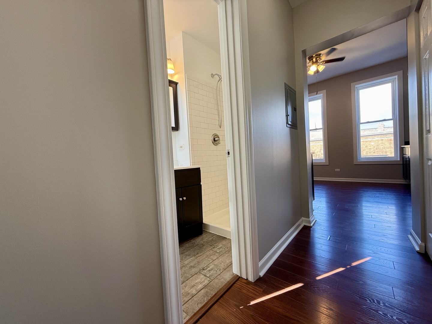 3235 South Racine Avenue, Unit 2M Chicago, IL 60608 - Photo 10 of 11 a view of a hallway with wooden floor and stairs