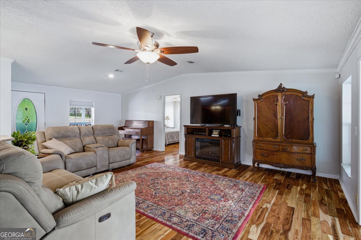 266 Payton Road Griffin, GA 30223 - Photo 11 of 48 a living room with furniture and a flat screen tv