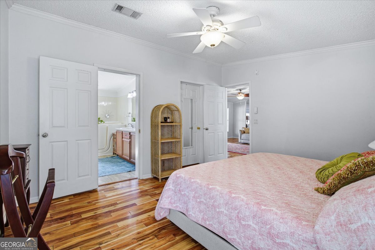 266 Payton Road Griffin, GA 30223 - Photo 17 of 48 a bedroom with a bed closet and a chandelier
