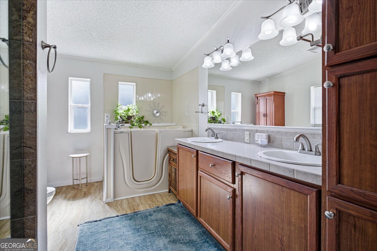266 Payton Road Griffin, GA 30223 - Photo 18 of 48 a spacious bathroom with a granite countertop sink a large mirror and a shower
