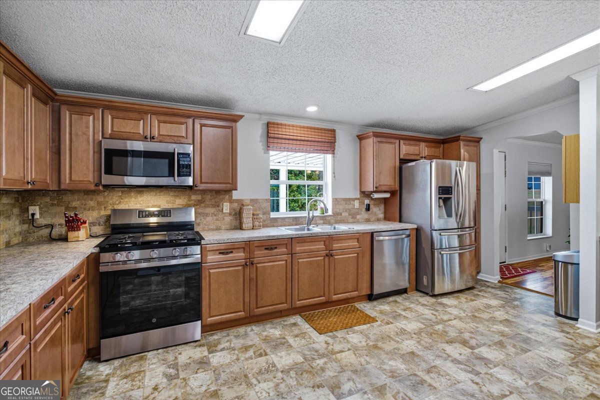 266 Payton Road Griffin, GA 30223 - Photo 6 of 48 a kitchen with stainless steel appliances granite countertop a stove refrigerator sink and microwave