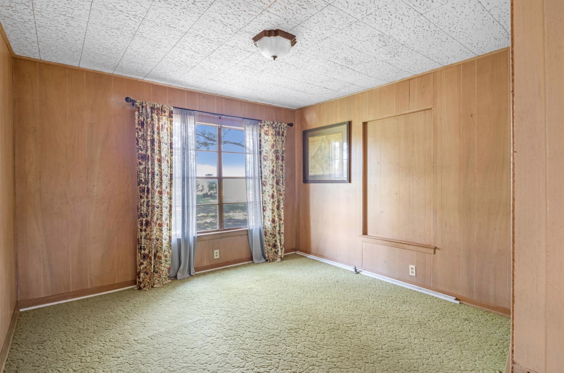 451 Pleasant Grove Road Elgin, TX 78621 - Photo 9 of 26 Spare room featuring baseboards, carpet floors, and wooden walls