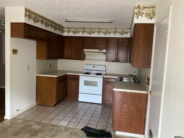 a kitchen with a stove and a refrigerator