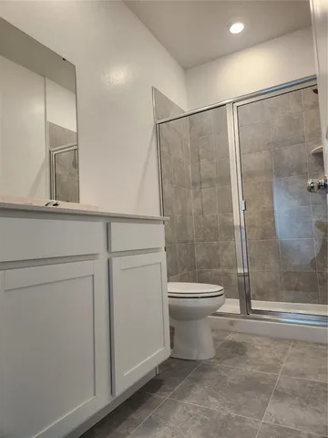 a bathroom with a toilet a sink and shower