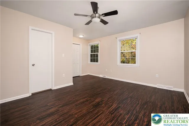a bathroom with a granite countertop sink toilet a mirror and shower