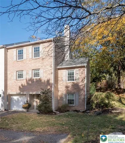 a view of a brick house with a yard