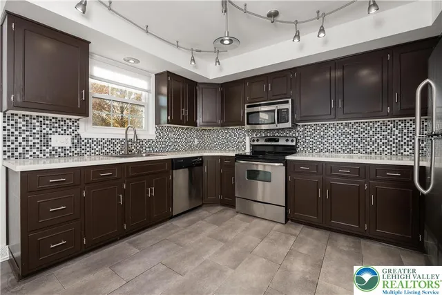 a kitchen with granite countertop cabinets and black appliances