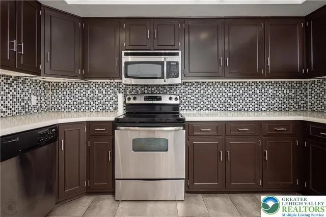 a view of a kitchen with refrigerator and microwave