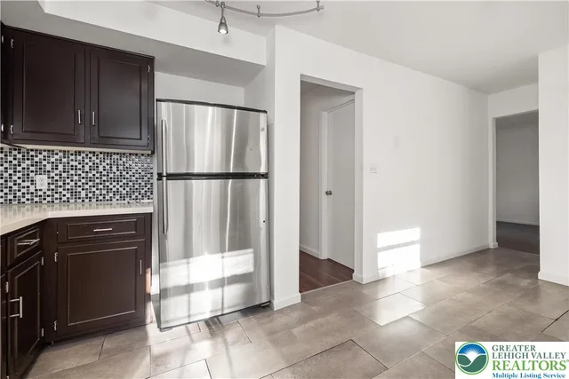 a view of an empty room with window and fire place