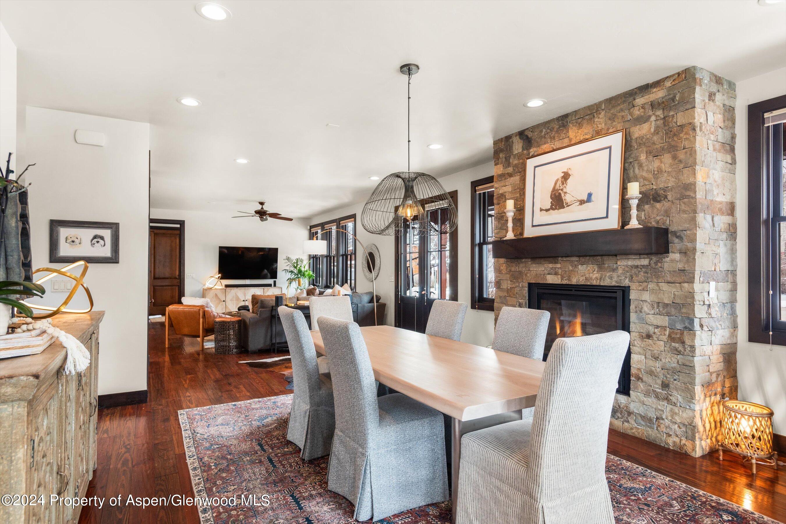 333 Sopris Circle Basalt, CO 81621 - Photo 11 of 57 a dining room with furniture a rug a fireplace and a chandelier