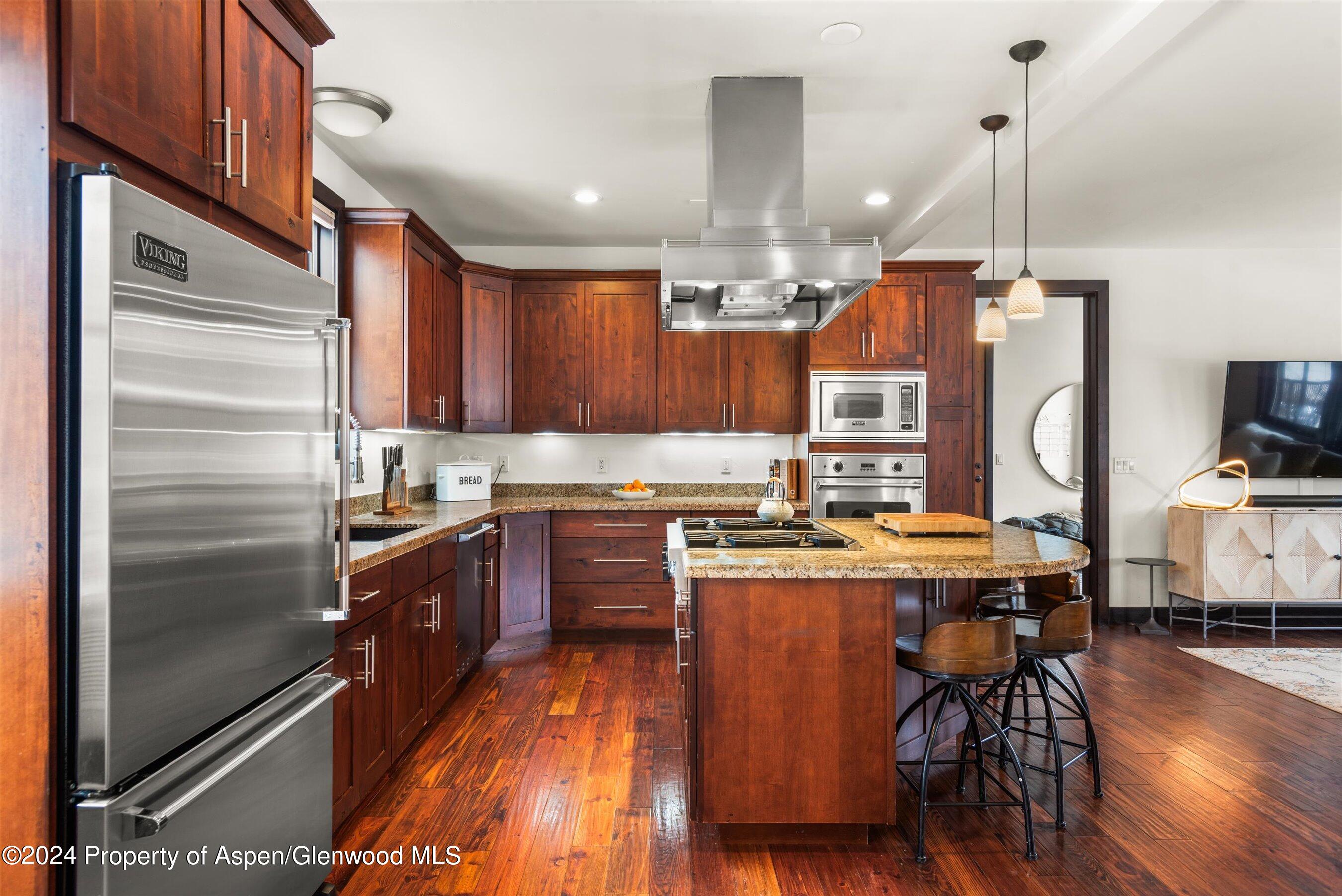 333 Sopris Circle Basalt, CO 81621 - Photo 17 of 57 a kitchen with stainless steel appliances granite countertop a refrigerator a stove and a wooden floors