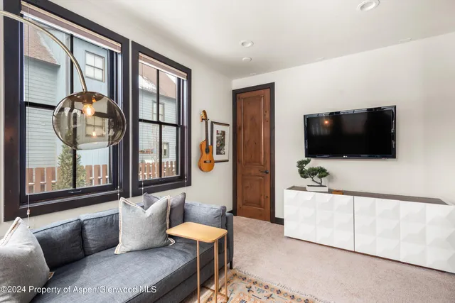 a view of a balcony with wooden floor and a window