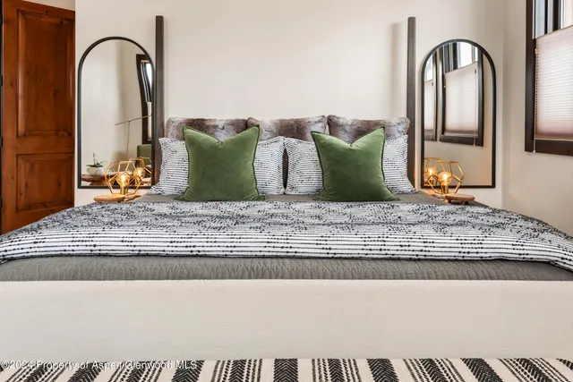 a bathroom with a granite countertop bathtub a double vanity sink and mirror