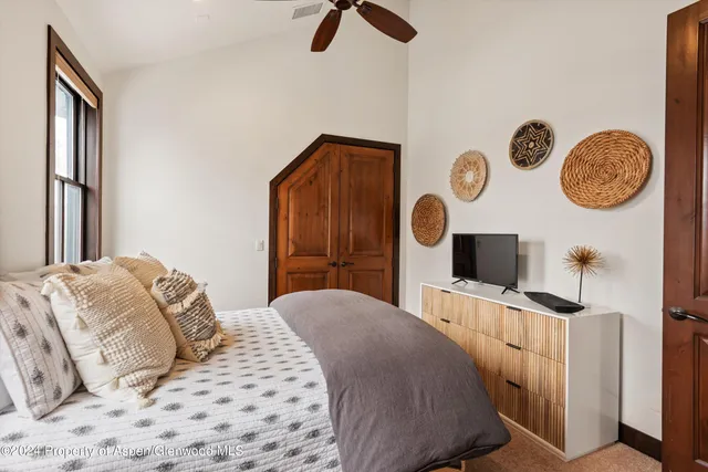 a bedroom with furniture and a window