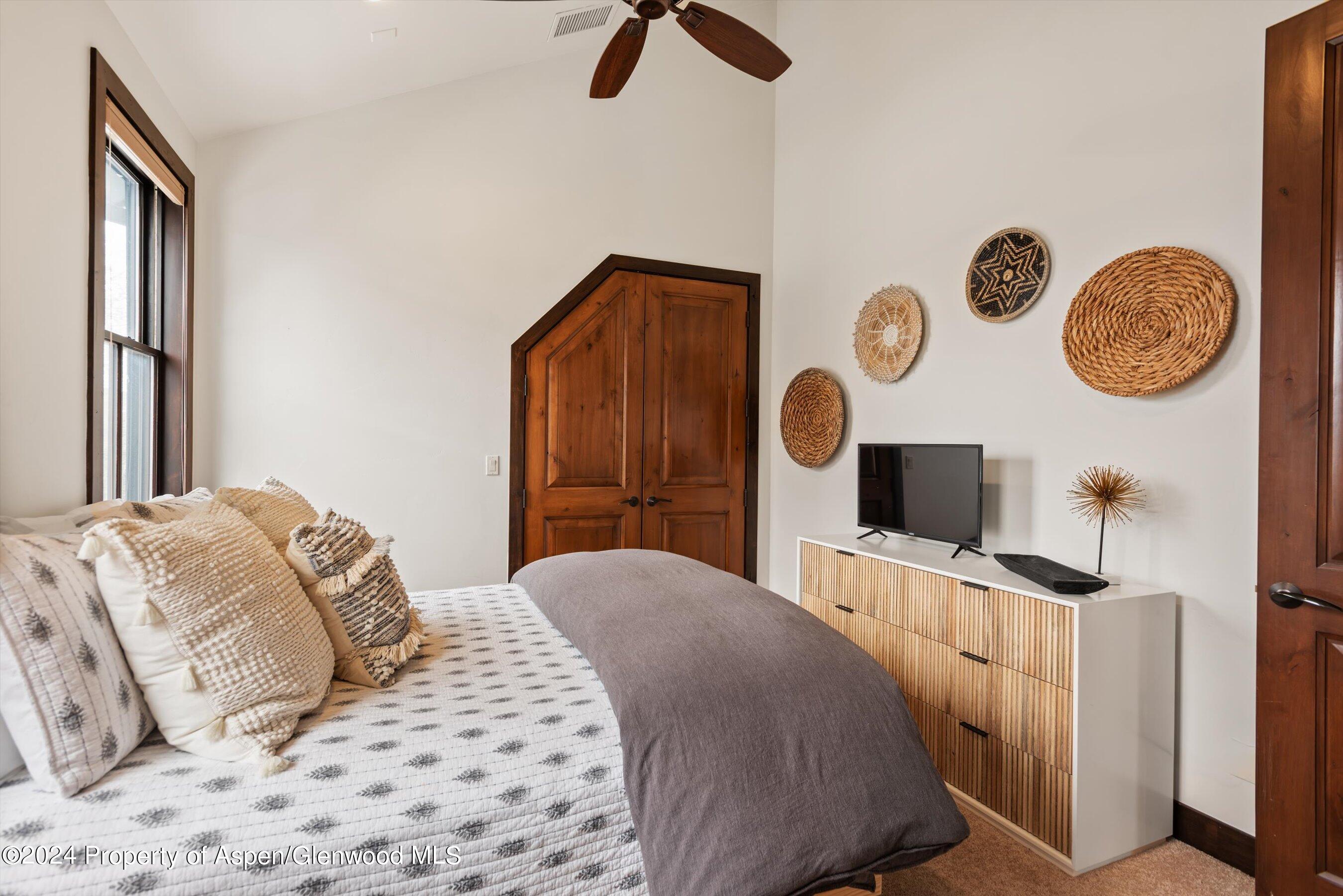 333 Sopris Circle Basalt, CO 81621 - Photo 35 of 57 a bedroom with a bed and a chandelier
