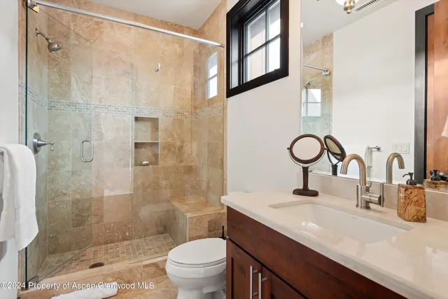 a bedroom with a bed a lamp and the window