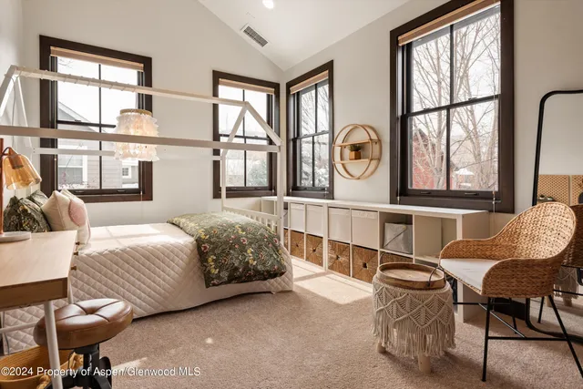 a living room with furniture a flat screen tv and a window