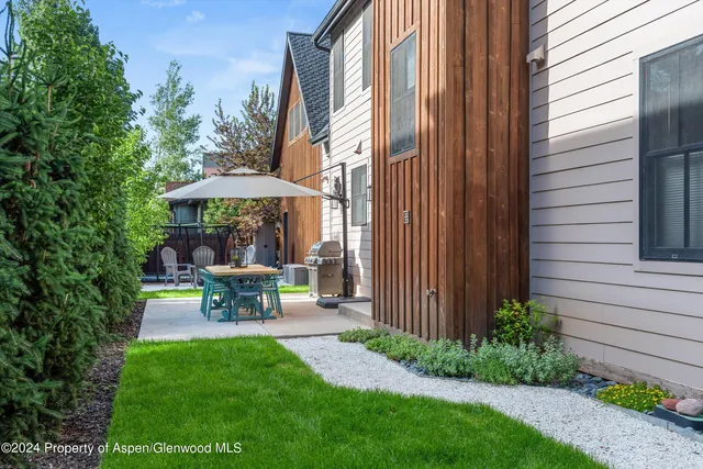 a view of a bench in backyard of house