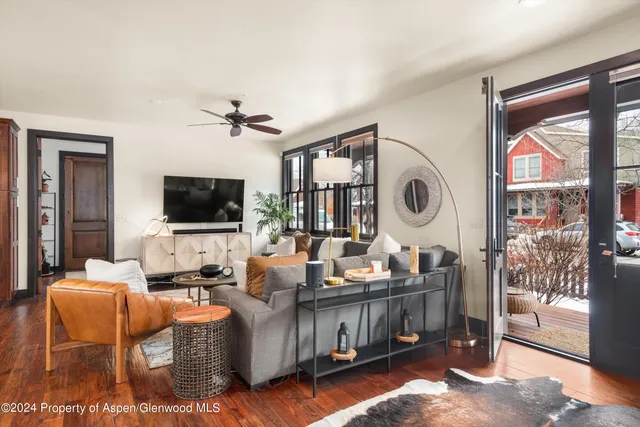 a living room with furniture and a flat screen tv