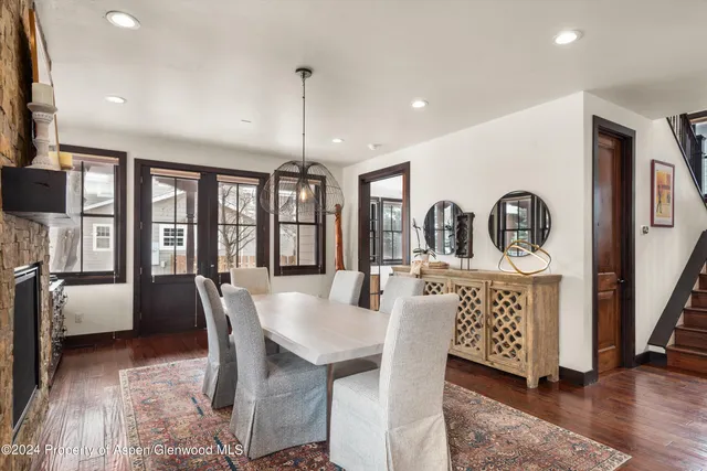 a dining room with furniture window and wooden floor