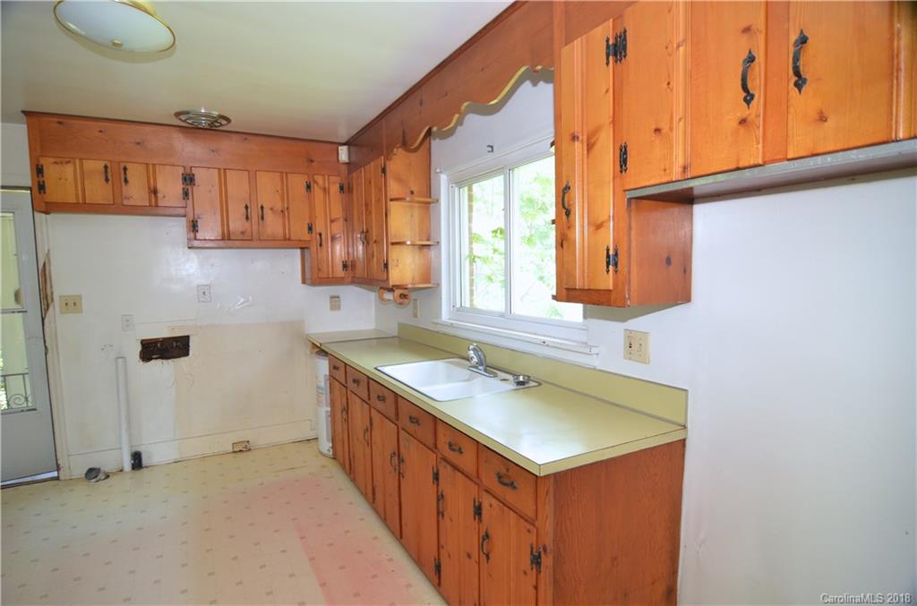 6207 Tuckaseegee Road Charlotte, NC 28208 - Photo 2 of 20 a bathroom with a sink and a mirror
