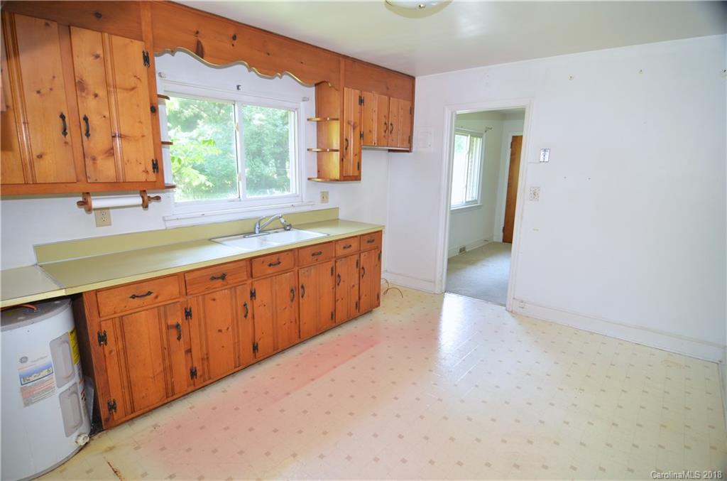 6207 Tuckaseegee Road Charlotte, NC 28208 - Photo 3 of 20 a kitchen with stainless steel appliances granite countertop a sink a stove and a refrigerator