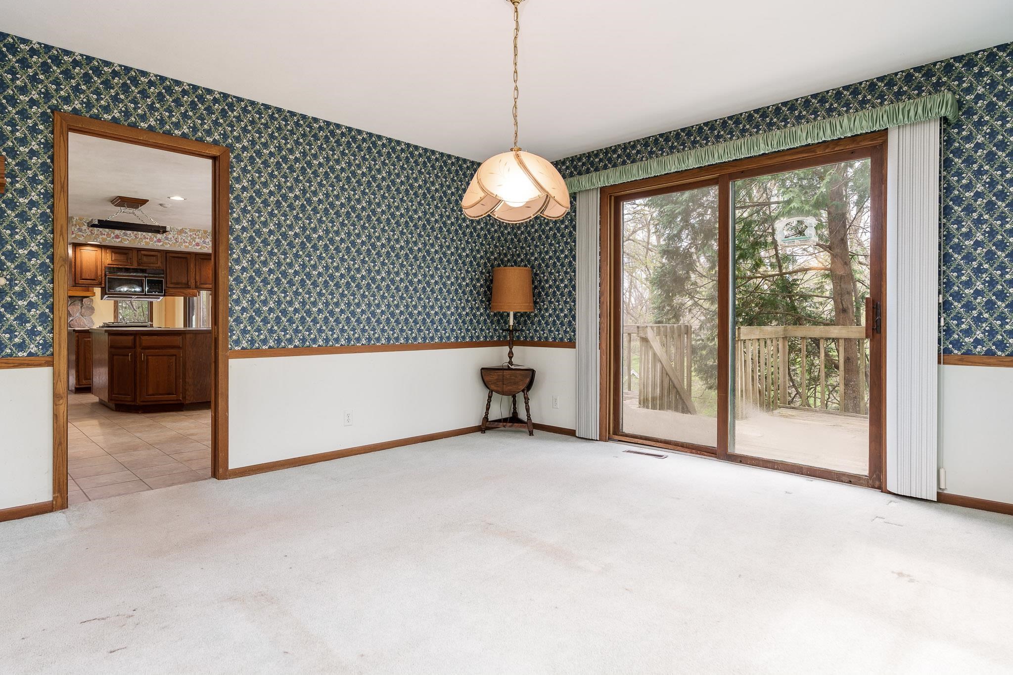 10245 Tybow Trail Roscoe, IL 61073 - Photo 12 of 63 a view of a room with a large window and chandelier