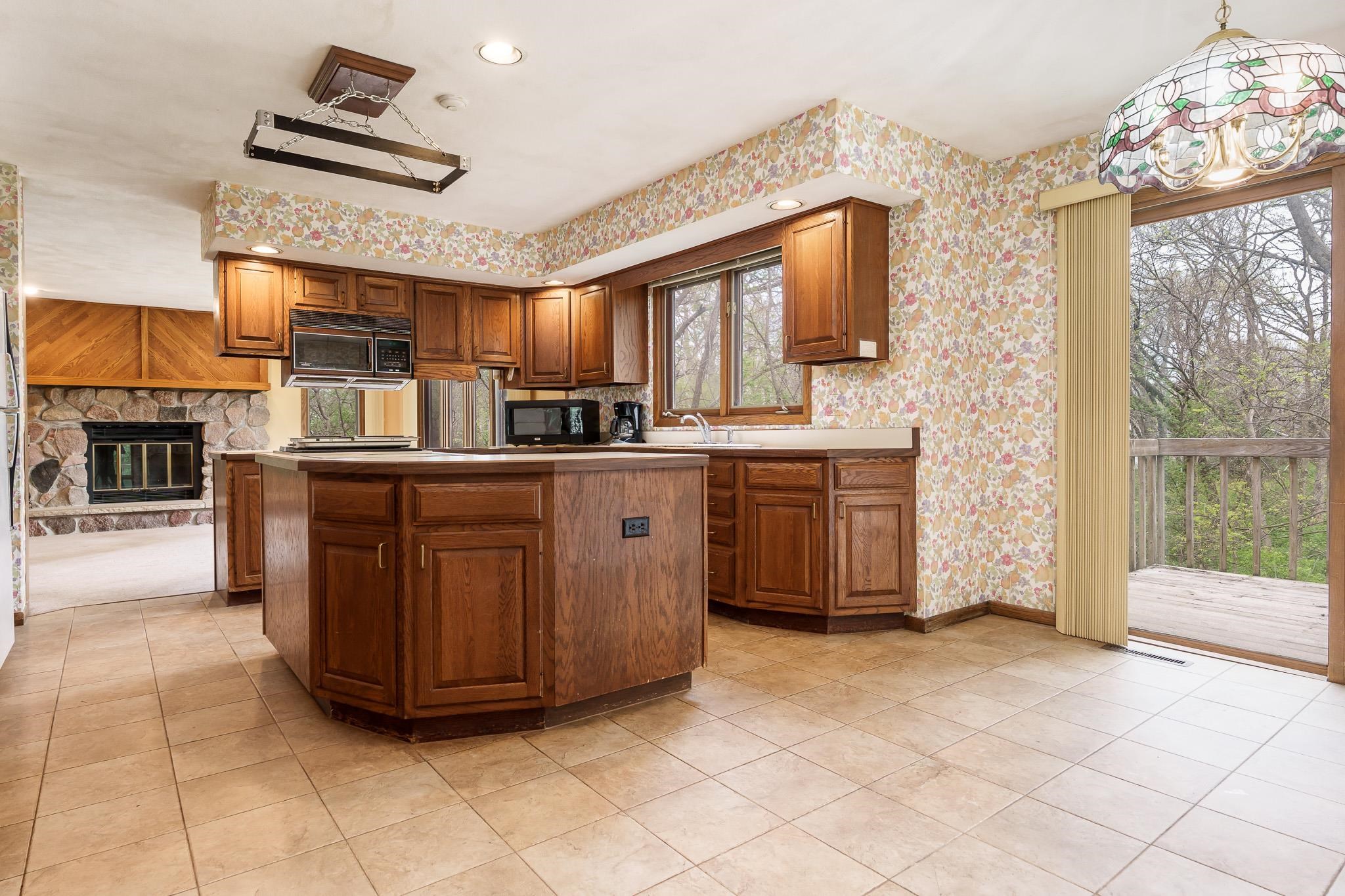 10245 Tybow Trail Roscoe, IL 61073 - Photo 13 of 63 a kitchen with stainless steel appliances granite countertop a stove a sink dishwasher and a refrigerator