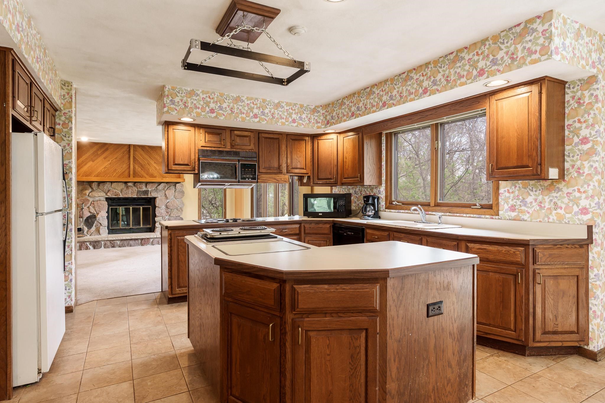 10245 Tybow Trail Roscoe, IL 61073 - Photo 14 of 63 a kitchen with stainless steel appliances granite countertop a sink a stove and a refrigerator