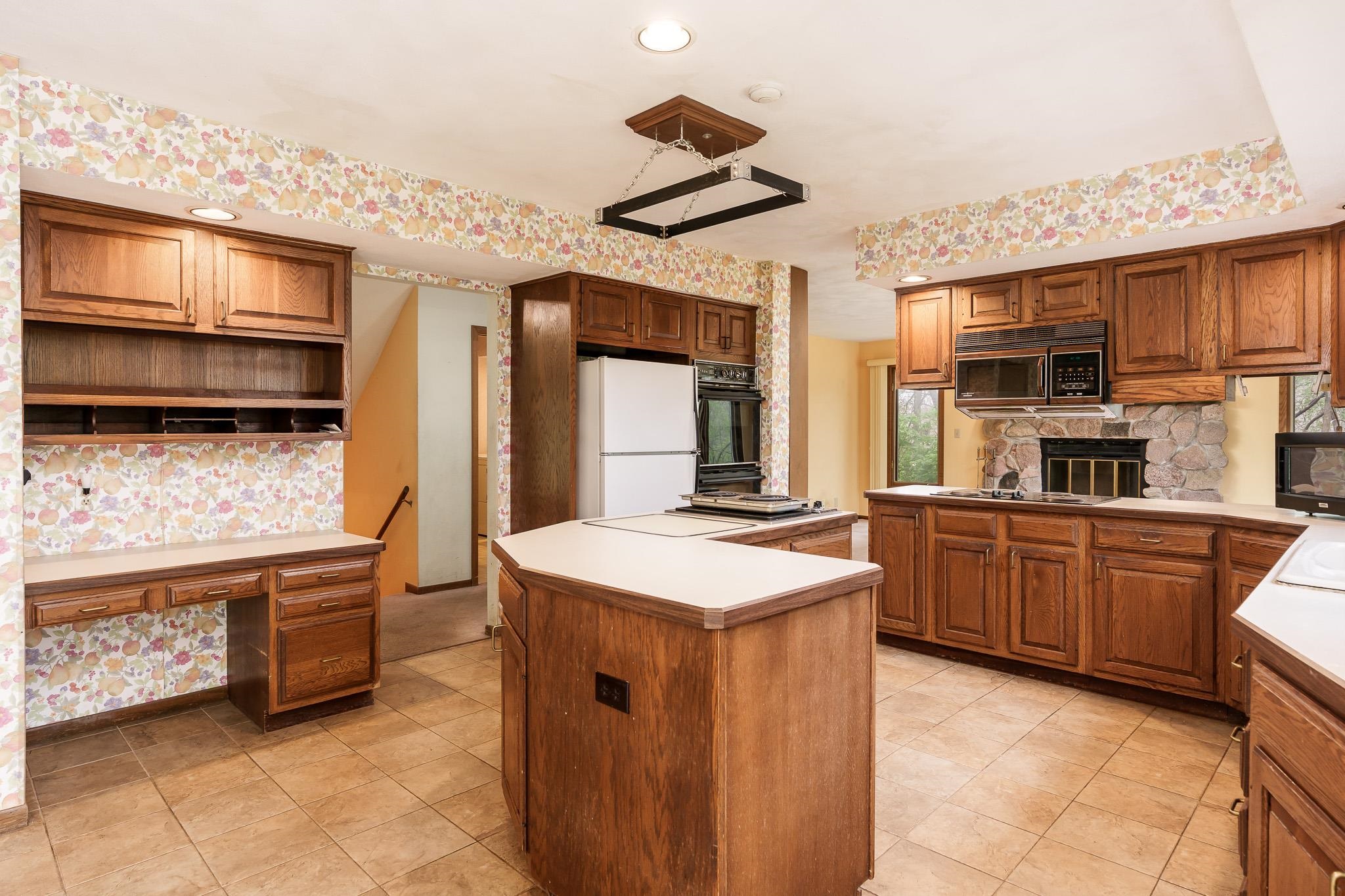 10245 Tybow Trail Roscoe, IL 61073 - Photo 15 of 63 a kitchen with stainless steel appliances granite countertop a stove and a sink