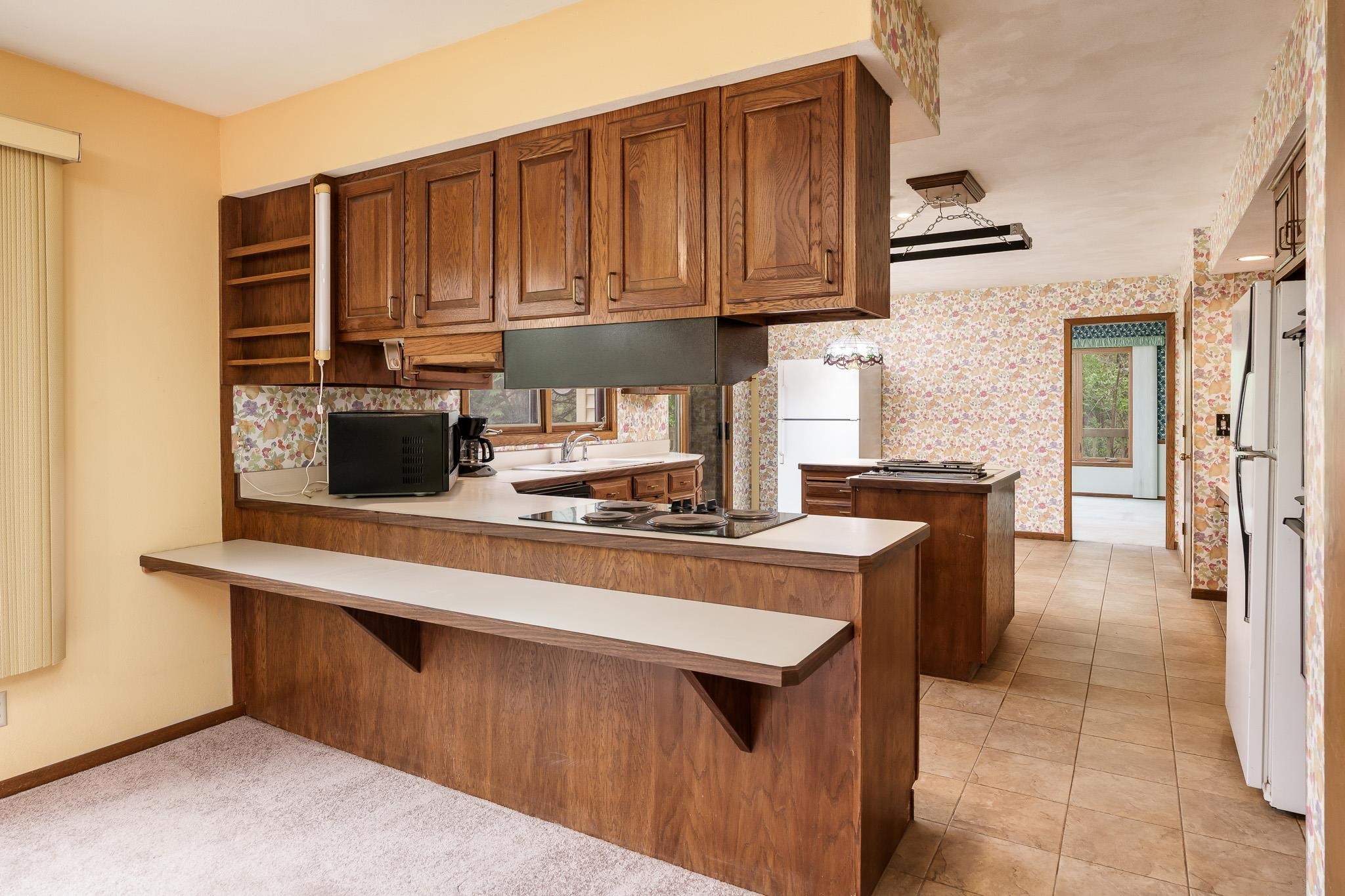 10245 Tybow Trail Roscoe, IL 61073 - Photo 18 of 63 a kitchen with stainless steel appliances granite countertop a stove a sink and a refrigerator