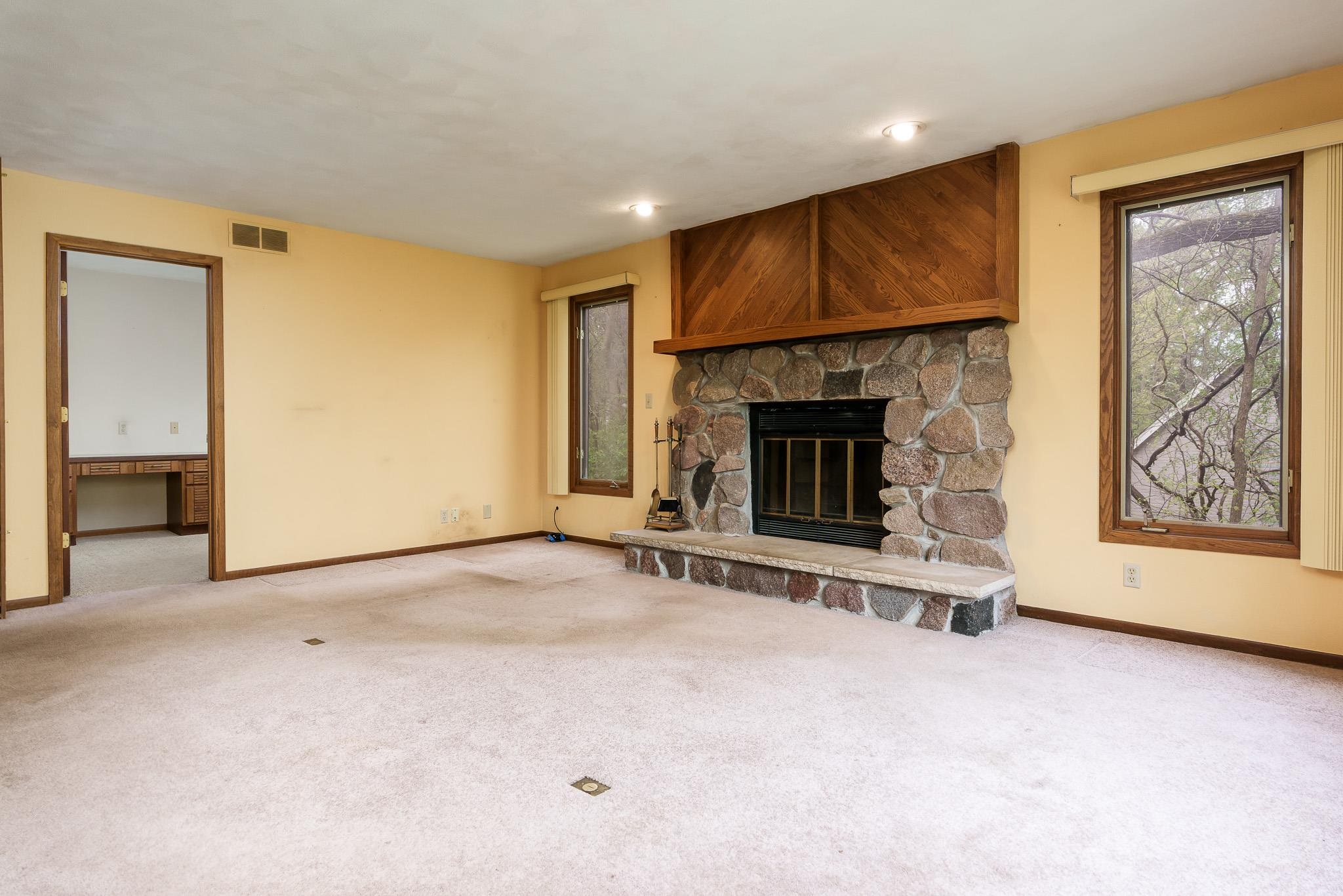 10245 Tybow Trail Roscoe, IL 61073 - Photo 23 of 63 an empty room with furniture and fireplace