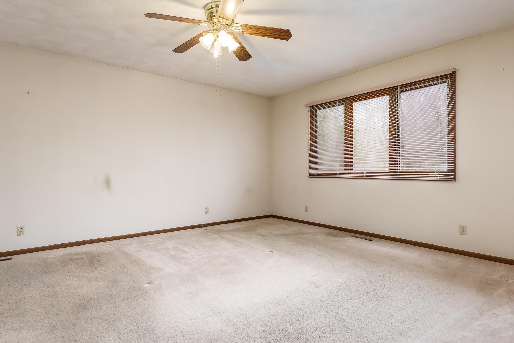 10245 Tybow Trail Roscoe, IL 61073 - Photo 30 of 63 an empty room with windows and chandelier fan